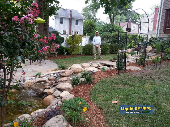 a tranquil meandering stream and koi pond grace this small backyard, landscape, ponds water features, A constant reminder for Dad and Mom that they made the correct decesion to have Liquid Designz install their dream