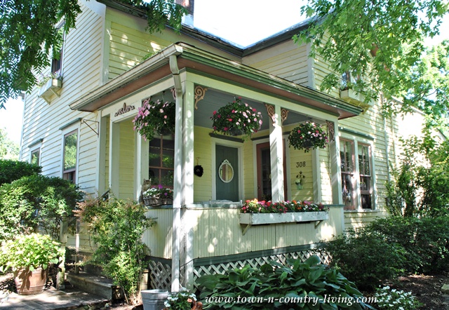 creating cozy country style on a budget, home decor, The front porch is dressed for summer with impatiens overflowing in hanging baskets At 28 apiece they pack a decorating punch for 84 and will stay in bloom through October