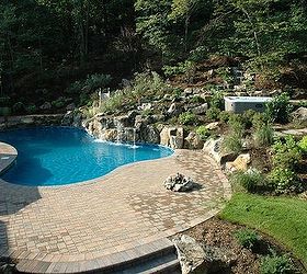 integrating a portable spa into a backyard oasis, landscape, outdoor living, ponds water features, pool designs, spas, Natural Looking Retaining Wall Transforming an existing hill included adding a portable spa and upper patio creatively tucked into it all