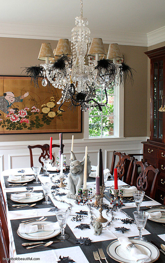 a stylish halloween table setting, halloween decorations, seasonal holiday d cor, We decorated the chandelier with feathers and beaded garland