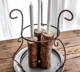 from firewood to christmas log candle centrepiece, christmas decorations, repurposing upcycling, seasonal holiday decor, A rusty old plant stand was flipped upside down for the crowing jewel Then fresh greens and faux snow sealed the deal