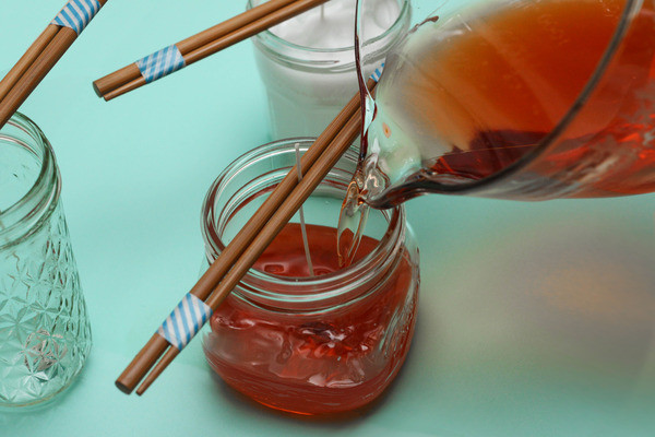 diy citronella candle, crafts, mason jars, Pour the wax into the jar Have the mason jar ready make sure the chopsticks are still resting on top for this next step Turn off the stove put on an oven mitt and very carefully remove the measuring cup of hot wax from stove