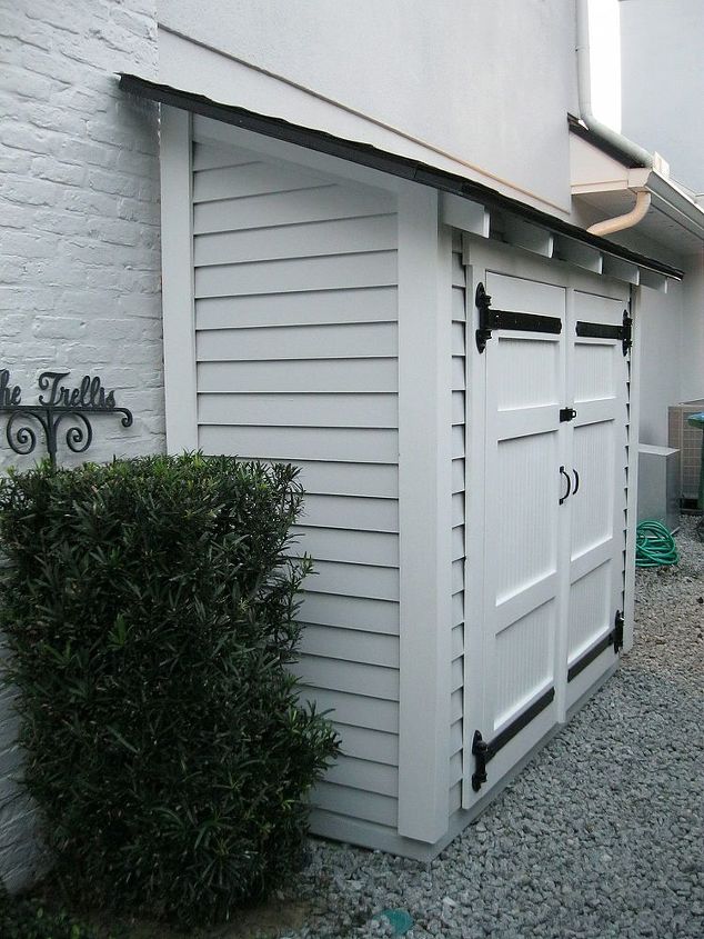 small storage for along the side of a house, outdoor living, shelving ideas, storage ideas, A small but attractive shed set along the side of a house With some shelves it can store quite a bit all with easy access Can also be placed next to a fence