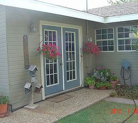 july bloomers in west texas, flowers, gardening, outdoor furniture, outdoor living, French doors with red petunias geraniums and birdhouses