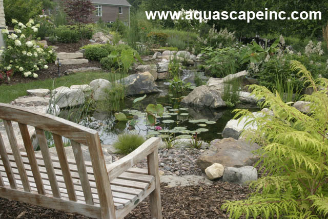 refresh your landscape with water, gardening, outdoor living, ponds water features, This landscape used to be all lawn and no pizzazz Now the homeowner can sit by their watery paradise on a rustic bench