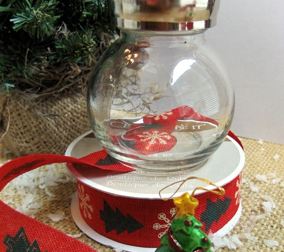 fun and easy salt shaker snow globes, christmas decorations, crafts, seasonal holiday decor, Just hot glue the little ornament to the bottom of the shaker add faux snow and a ribbon to create these waterless snow globes