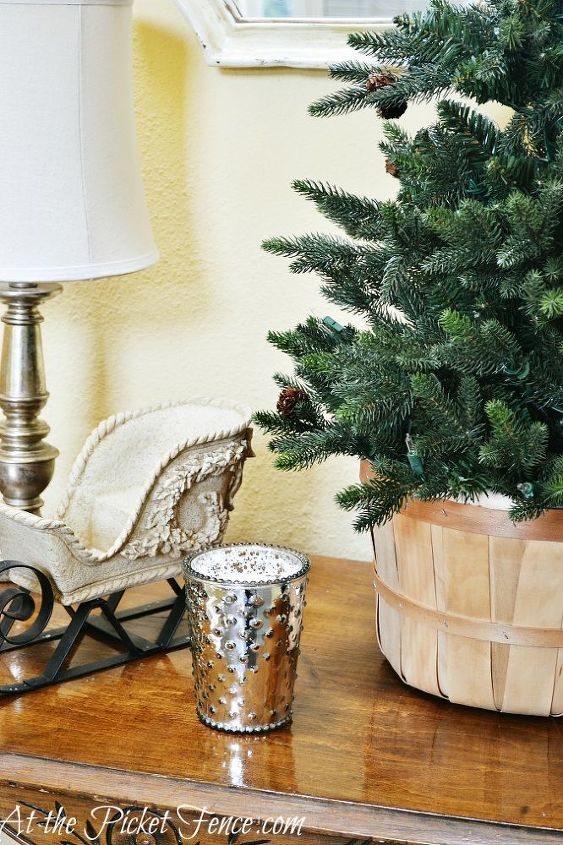 from christmas to winter in a few simple steps, fireplaces mantels, seasonal holiday d cor, I kept the sleigh on the table took the top off the Christmas tree and placed it in a basket A mercury candle adds a bit of sparkle to finish it off