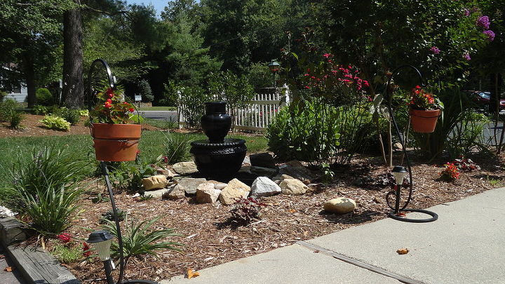 vintage iron cauldron and kettle fountain, flowers, outdoor living, patio, ponds water features, Dug a whole for a tub 32 diameter We used an old flower urn and a bubbler urn to make a fountain This is the result of our yard sale finds