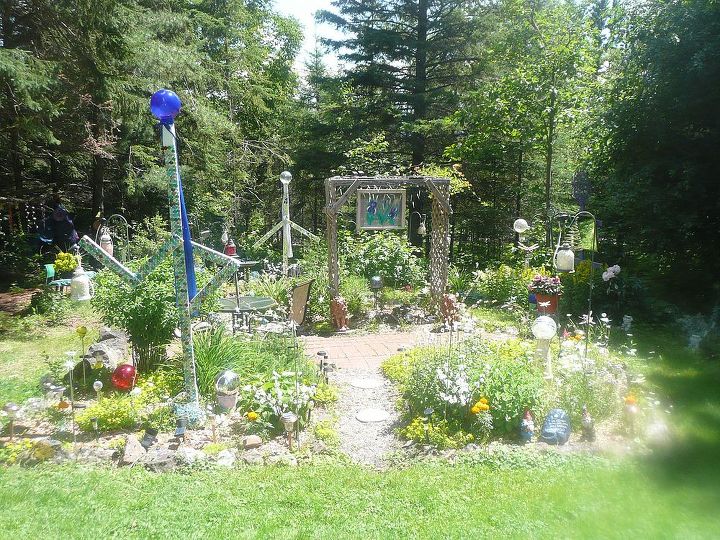 whimsical garden ideas, gardening, We have 2 people forms One has a blue mirror ball head and blue sequined scarf He is covered in colored glass gems The one in back has a silver mirror ball head and silver sequined scarf He is painted white with glass pieces