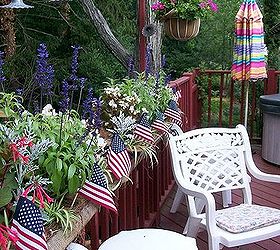 patriotic picnic bbq happy memorial day, outdoor living, patriotic decor ideas, seasonal holiday decor, American flags were added to the deck planters planted with white begonias blue ageratum and red fuchsias