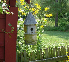 placing birdhouses in the garden, flowers, gardening, You can use older styles and home made birdhouses as well to add character to your buildings fences and walkways