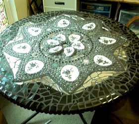 mosaic table, crafts, painted furniture, tiling, I used black plates I bought at wal mart a buck a piece my slurge on expenses so that this would all come together color wise grouting it was a lot of work but this is now a great addition to my yard