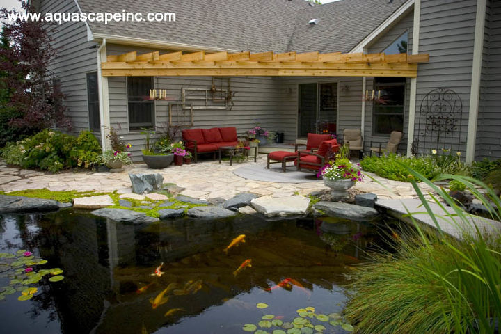 outdoor living with water gardens, curb appeal, decks, outdoor living, patio, ponds water features, A mix of stone lends interest to the patio The pond comes right up to the patio providing a great place to dangle your feet and feed the fish