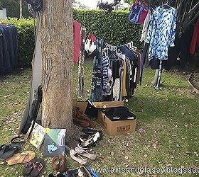 my garage yard moving sale tips, cleaning tips, outdoor living, 5 Hang up Clothes It s much easier for your shoppers to find the cute clothes you are selling I suggest hanging a rope or wire between trees to display this Or hang them on a picket fence We found that to amazing for hanging cl