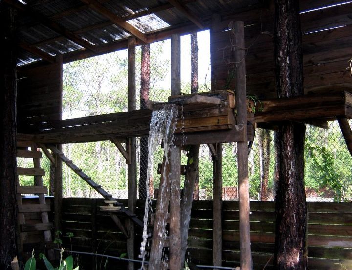 fort getaway, rustic waterfall inside aviary over cement turtle pond