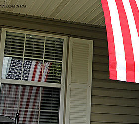 celebrating the red white and blue in style, outdoor living, patriotic decor ideas, seasonal holiday decor, My favorite thing on the porch is the large flag flapping in the breeze