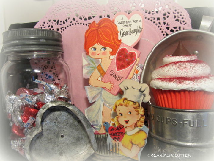 a valentine s day vintage kitchen vignette, seasonal holiday d cor, valentines day ideas, I added more candy a faux cupcake more vintage kitchen utensils and a couple of my childhood Valentines to complete the vignette