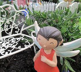 a fire pit fairy garden two versions choose your favorite, crafts, gardening, repurposing upcycling, A fairy by her white wire bench