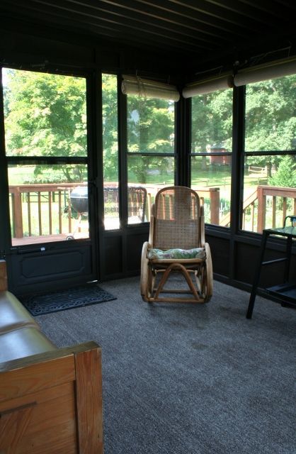 a sun room of thrifted furniture, outdoor furniture, outdoor living, painted furniture, repurposing upcycling, Walking into the room from the house you see the love seat to the left and the rocking chair in the corner