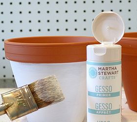 how to make decorated clay pots for spring, chalkboard paint, crafts, painting, Using a dry paintbrush lightly brush white gesso around the outside of the pot below the rim Brush lightly and add layers letting each layer dry in between