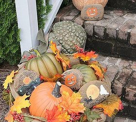 festive fall and spooky halloween front porch decor, crafts, halloween decorations, porches, seasonal holiday decor, wreaths, Fall Front Porch Decor vignette created in a vintage metal child s wheelbarrow I nestled rocks handpainted with Halloween scenes in with pumpkins and fall foliage