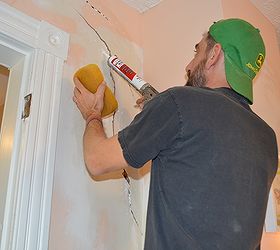how to repair a large crack in plaster, diy, home maintenance repairs, how to, wall decor, Apply adhesive using a caulk gun squirting into holes and cleaning up with a sponge Tip cut only the tip of the tub off