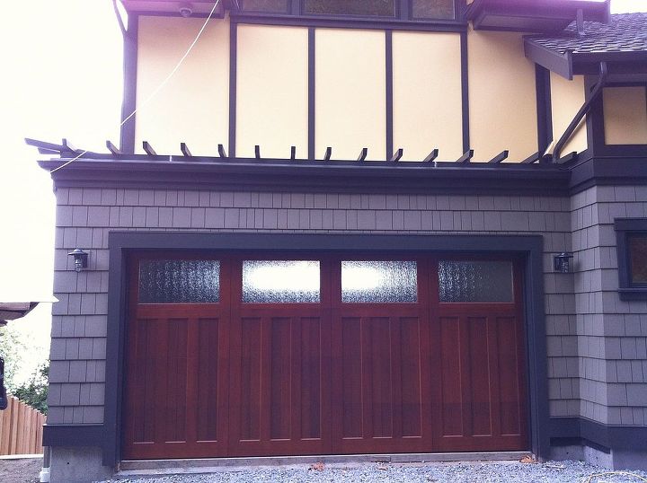 wood carriage house garage doors, Clopay Reserve Collection Custom insulated garage door Factory Stained Mahogany w rain glass