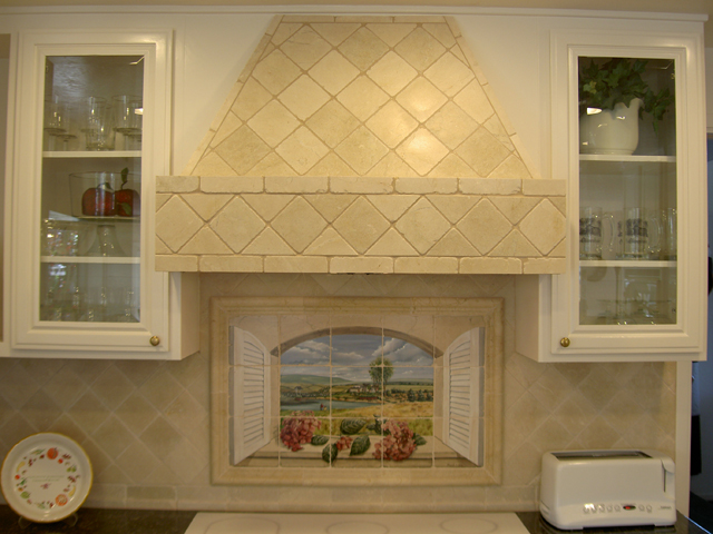 kitchen backsplash, kitchen backsplash, kitchen design, tiling, The original hood in this project was a dated wooden one 4 tumbled crema marfil was applied directly to the wood to give it an updated look Shutters included in the mural make the window illusion more realistic