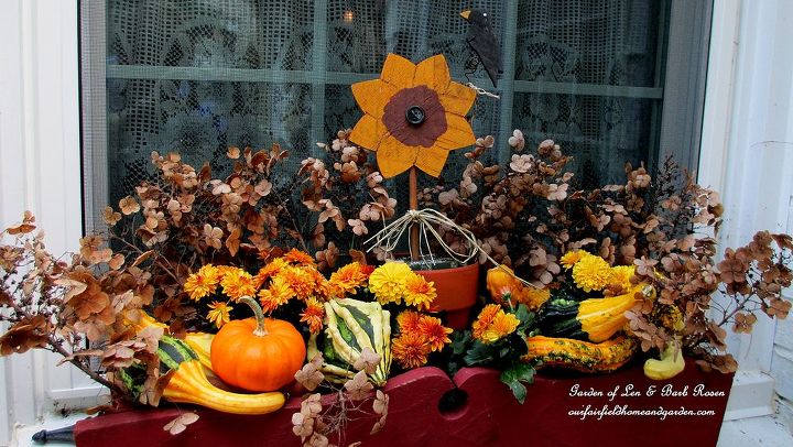 fall decorating time, container gardening, flowers, gardening, halloween decorations, home decor, hydrangea, seasonal holiday d cor, Here s our kitchen deck decorated for Fall with Tipsy Punkin Heads and mums gourds dried oakleaf hydrangea in the window box