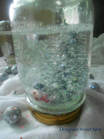 mason jar snow globes, crafts, mason jars, repurposing upcycling, Then I added 3 Tablespoons of glycerin per jar dumped in some glitter and filled the jar 3 4 full with water