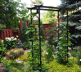 a garden in the shade, This is an arbor that leads into a small corner nook that is both half shade to the left and full sun on the right