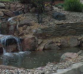 water features through walls, gardening, landscape, outdoor living, ponds water features, wall decor, The homeowners took an ordinary backyard with an extreme slope and turned it into a beautiful landscape with this pond and stream running through their retaining wall at Parker CO