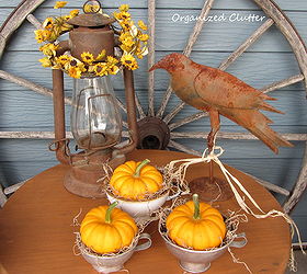 a rustic vintage fall covered patio, outdoor living, seasonal holiday decor, Canning funnels mini pumpkins and a rusty lantern and crow on the crock table