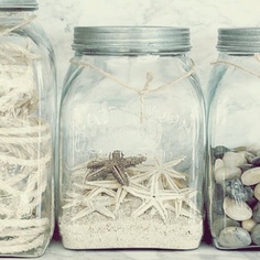 coastal home design ideas, halloween decorations, seasonal holiday d cor, wreaths, If you don t have a coastal home but you like the idea of keeping summer alive repurpose mason jars Wash them thoroughly and fill with nothing but items you can find on the beach sea dollars sea shells starfish and sand