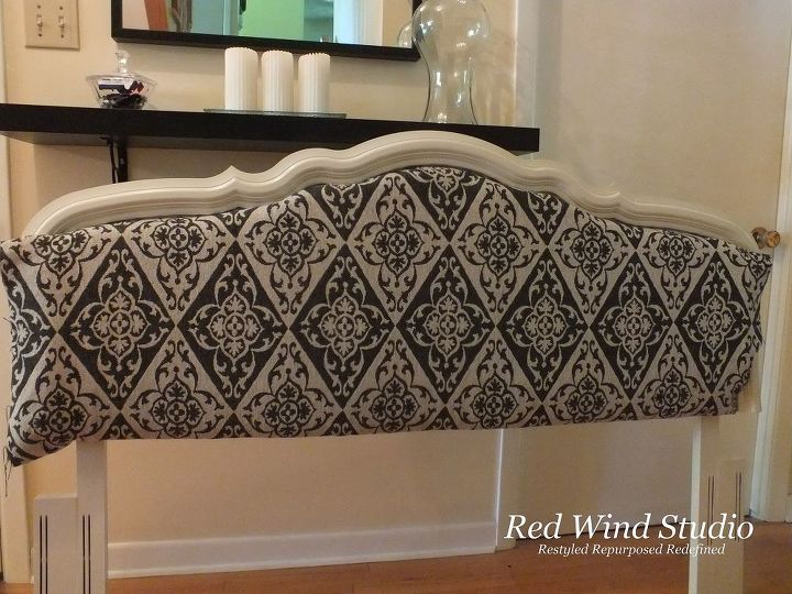 I won’t go into all the detail as to how I managed to get the material onto the headboard as it was extremely awkward and I know now that I did it probably the most difficult way possible. I certainly don’t want to give you instructions on how to get frustrated. Let’s put this one up to a learning lesson and say the next one will be easier. There is another lesson here and it isn’t how to upholster.
I did staple the material and I used the decorative nails around the edge of the material. I am sure I bent about a third of the nails and had to toss them away. I discovered press board is very hard.