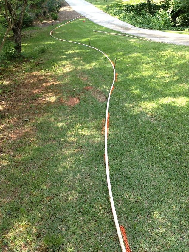 a trick to laying out near perfect curved bedlines, concrete masonry, landscape, The pieces of PVC pipe set out and marked to create the new flowing bedlines I was using 120 feet of pipe to create these long bedlines