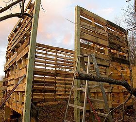 making a pallet barn, diy, pallet, repurposing upcycling, woodworking projects, The corner posts are treated 4x4s They are anchored to the ground and help to support the 2nd story of pallets