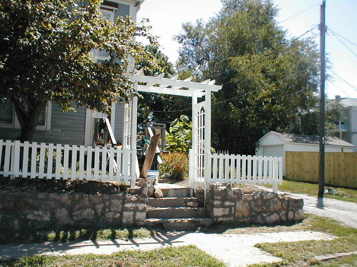 new arbor and revamped old fence, curb appeal, fences, outdoor living, one of my neighbors hit the corner of my retaining wall one icy winter so fixing that was the original goal which soon became a whole lot more than rock work