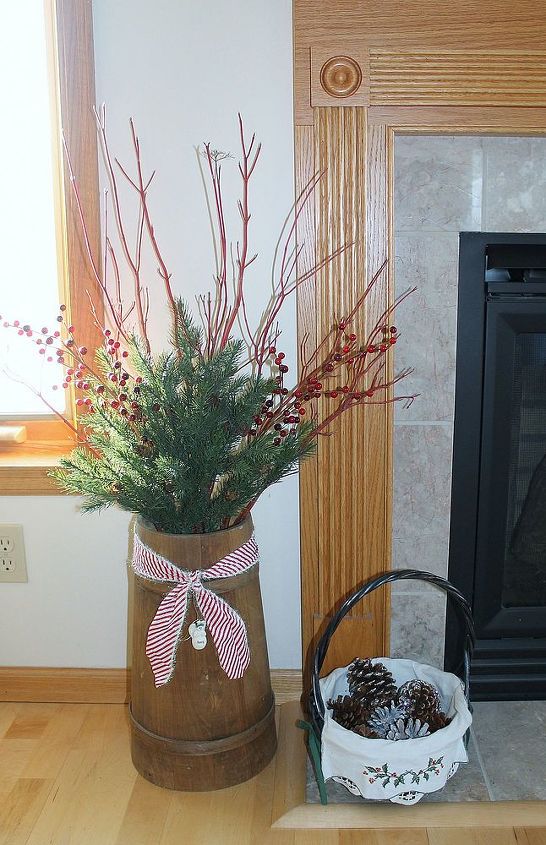 a country christmas, christmas decorations, seasonal holiday decor, I used an old butter turn to make this simple arrangement The basket was given to me by our daughter several Christmases ago another treasured gift