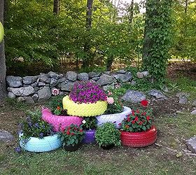 repurposed tires spray painted and turned into planters, gardening, repurposing upcycling