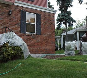 how we washed our aluminum siding, cleaning tips, curb appeal, Before we started we wet down our grass thoroughly and covered our other plants so they wouldn t drink up the TSP