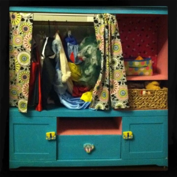 transform an old entertainment center into a dress up station, painted furniture, hide the dress up clothes behind the curtain