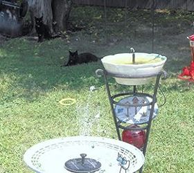 solar lights fountains bird baths water for cats dogs too, ponds water features, repurposing upcycling, The white table base was once a water garden I found a fan screen on the road side and cut the center out to hold the floating solar fountain in place
