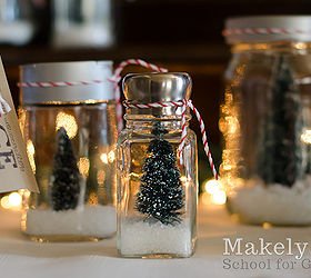 christmas tree snow jars in 4 easy steps, christmas decorations, crafts, mason jars, repurposing upcycling, seasonal holiday decor, 2 Next I added a few drops of hot glue to the bottom of little Snow Village trees that I bought at Home Depot I glued the tree inside the jars