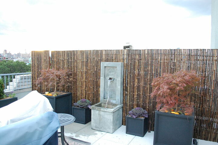 nyc rooftop, outdoor living, urban living, Bamboo fence screening unsightly storage area