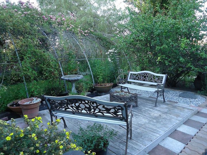 we can t decide on whether to use benches or white table and two chair, decks, outdoor furniture, outdoor living, painted furniture, rustic furniture, Okay away went the bench and table Out came two old benches that we had forgotten about I love the wrought iron Added a living wrought iron planter as a living table