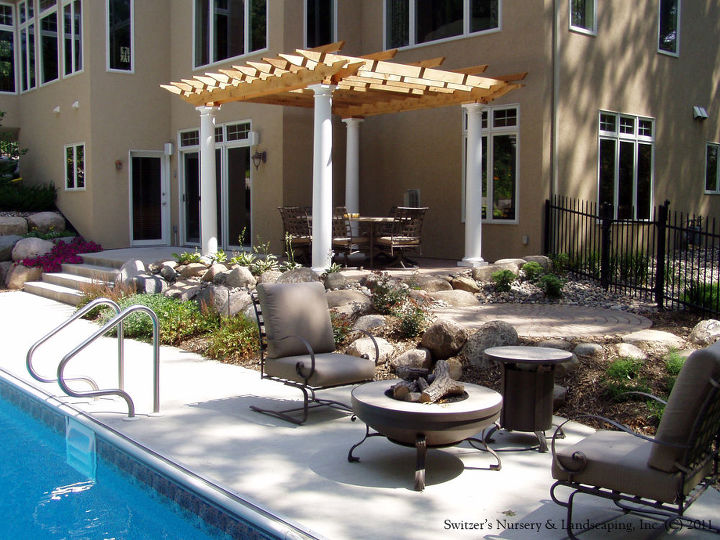 custom arbors amp pergolas by switzer s, outdoor living, Pergolas can be used to create human scale The space is made more comfortable by adding a visual ceiling to the back of the large house An outdoor dining area is much more cozy with the room feeling created by the pergola
