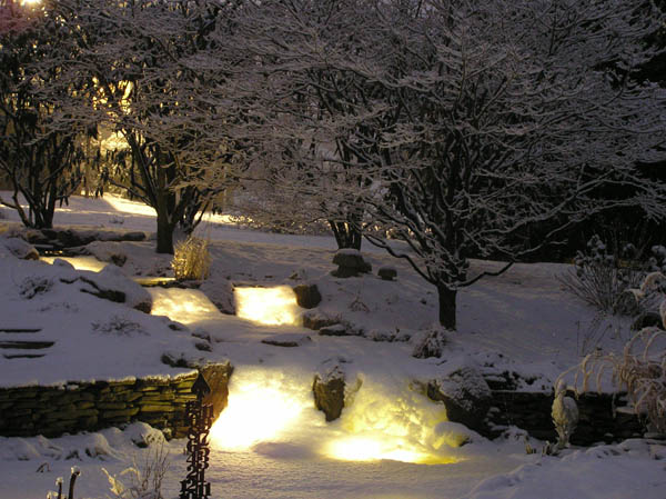 create a cozy winter water garden, gardening, lighting, outdoor living, ponds water features, Snow has covered the waterfall lights creating a magical glow