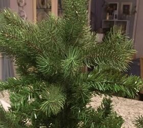 She cuts a few branches off their Christmas tree to beautify her countertop