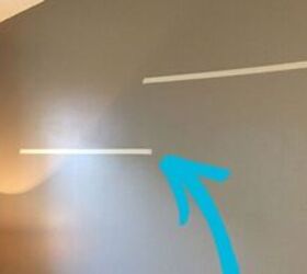 Why you should stick two strips of tape on the empty wall above your sofa&nbsp;